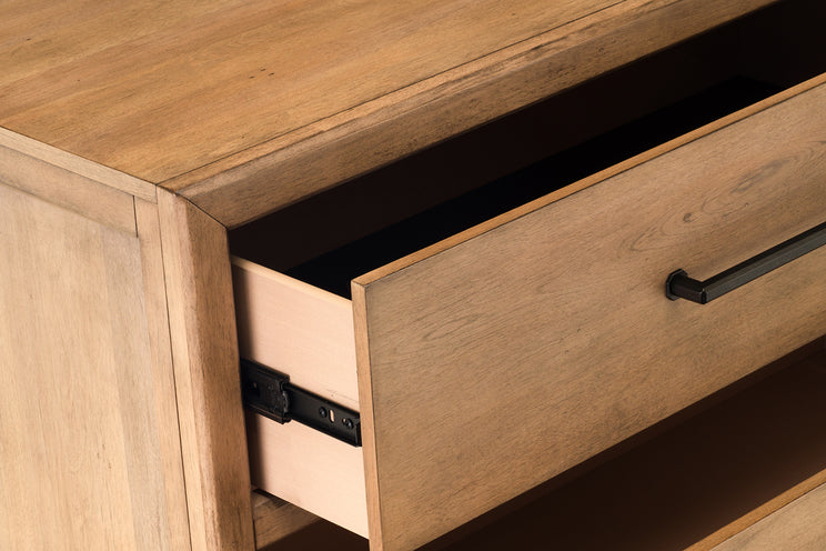 Wooden drawer with a metal handle on a wooden cabinet.